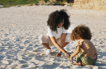 Poster - Black family at the beach, mother and child play in sand on summer holiday, freedom and travel with nature outdoor. Fun together, vacation and carefree with happiness, woman and girl in Jamaica