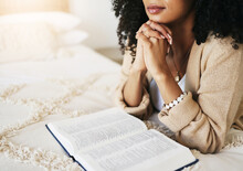 Bible, Prayer And Hands Praying For Hope, Religion Or Help, Spiritual Or Faith In Home. God, Christian And Female Or Woman Worship Jesus Christ Or Holy Spirit With Catholic Text Or Book For Peace.