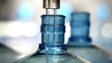Water Factory Bottling Filling Pure Spring Water Into Bottles. Bottle Neck Focus Closeup