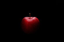Fresh Red Apple Isolated On Black Ground. Close-up.