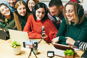 Wall Mural - Happy friends having fun streaming online doing podcast - Content creator and interview concept - Focus on center girl face