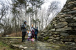 © AS Photo Family - Family tourist with three children, stand near stone monument in forest.