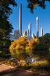 Central Park by The Pond in Fall with Billionaires Row skyscrapers. Midtown Manhattan, New York City