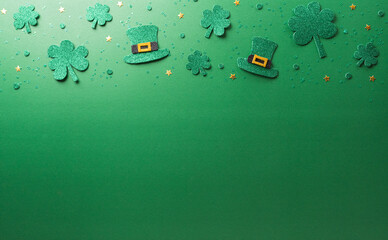 Wall Mural - Happy St Patrick's Day decoration concept made from shamrocks ( clover leaf) and leprechaun hat on green background.