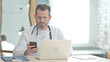 © stockbakers - Doctor using Smartphone at Work in Clinic