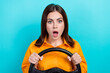 Portrait of astonished impressed girl bob hair dressed yellow shirt hold steering wheel open mouth isolated on blue color background