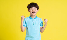 Portrait Of An Asian Boy Posing On A Yellow Background