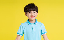Portrait Of An Asian Boy Posing On A Yellow Background
