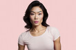 © ADDICTIVE STOCK - Generated AI portrait of attractive young ethnic female in white casual cloth looking at camera with astonished face while standing on pink background in studio
