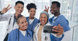 © D Lahoud/peopleimages.com - Doctors, team and selfie with diversity and health group, happiness with collaboration and smartphone photography. Medical professional, happy in picture and people in medicine with peace hand sign
