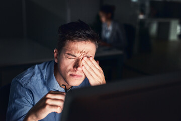 Sticker - How can I be productive with this headache. Shot of a young businessman working late at night in a modern office.