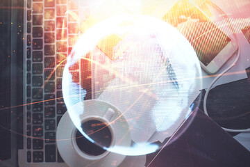 Fototapete - Business theme hologram drawings over computer on the desktop background. Top view. Multi exposure. Concept of international connections.