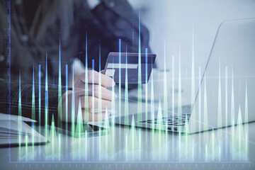 Poster - Multi exposure of woman on-line shopping holding a credit card and financial graph drawing. Stock market E-commerce concept.
