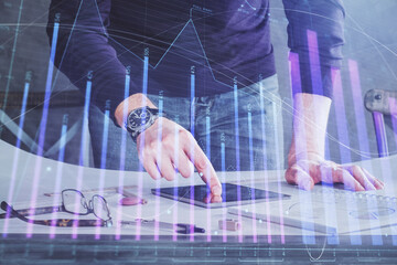 Poster - Double exposure of man's hands holding and using a digital device and forex graph drawing. Financial market concept.