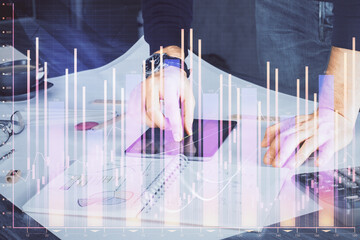 Poster - Double exposure of man's hands holding and using a digital device and forex graph drawing. Financial market concept.