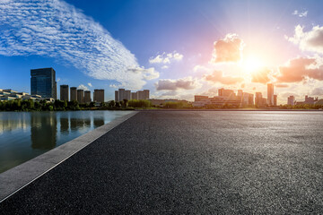 Asphalt road platform and modern city skyline with buildings at sunset in Ningbo, Zhejiang Province, China. 