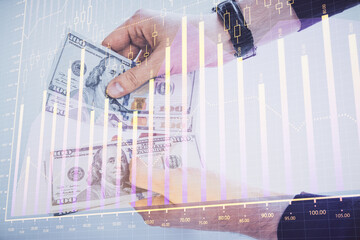 Poster - Multi exposure of financial graph drawing hologram and USA dollars bills and man hands. Analysis concept.