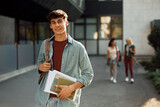 Fototapeta  - Portrait of male college student at campus looking at camera.