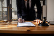 © SOMKID - lawyer working with contract agreement at table office, law and justice concept, Selective focus.