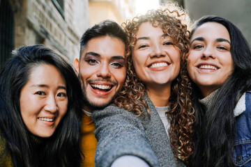 Diverse group of friends having fun taking selfie outdoors - Focus on gay transgender man wearing makeup - Travel holidays concept