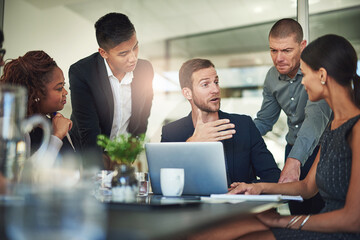 Aufkleber - Tell me more.... Shot of a group of businesspeople meeting in the boardroom.
