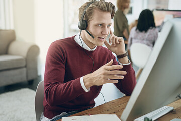Aufkleber - Delivering a high quality customer experience with every call. Shot of a young man using a headset and computer in a modern office.