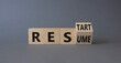 © Natallia - Restart and Resume symbol. Turned wooden cubes with words Resume and Restart. Beautiful grey background. Business and Restart and Resume concept. Copy space