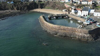 Wall Mural - Crail, a historic fishing village on the east coast of Scotland in the East Neuk of Fife. Low level aerial footage of the pretty little harbour. Lovely reflections of whitewashed houses in the water.