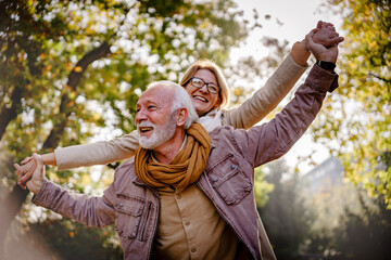 Portrait of a beautiful senior couple in the public park. Early retirement