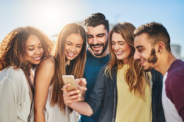 Aufkleber - Check out this new app. Shot of young friends using a smartphone outside.