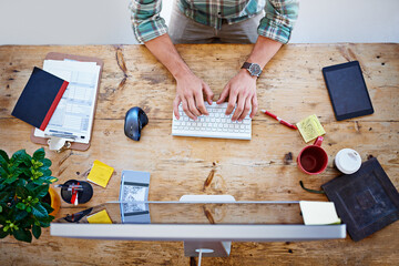 Poster - He has everything he needs at his disposal. High angle shot of a designer sitting at a desk working on a computer.