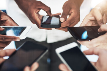 Canvas Print - Connecting online and in real time. Cropped shot of a group of people using their smart phones in synchronicity.