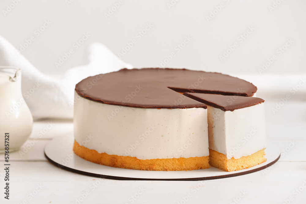 Sweet birds milk cake on light wooden table