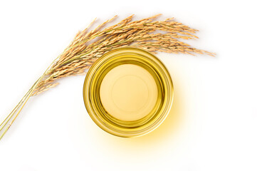 Top view of Rice bran oil in bowl with rice ears isolated on white background. Top view
