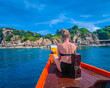 © Audrius - First person view of a traditional long tail boat with a girl sitting in front in Andaman sea in Thailand, Koh Tao island