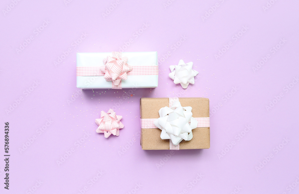 Gift boxes with bows on lilac background
