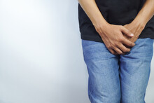Close Up Of A Man With Hands Holding His Crotch, Urinary Tract Infection Concept Painful Bladder Syndrome And Interstitial Cystitis