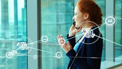Poster - Animation of connected globe and graph icons over happy caucasian woman talking on phone in office