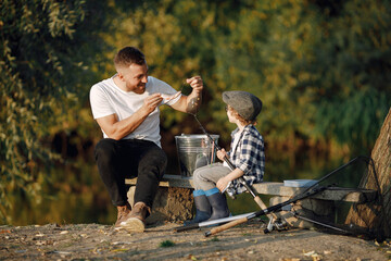 Canvas Print - Young father teaching his little toddler son how to fish