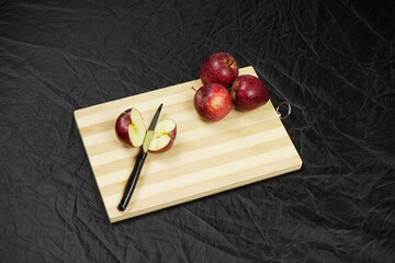 Wall Mural - Sliced apple with knife on chopping board
