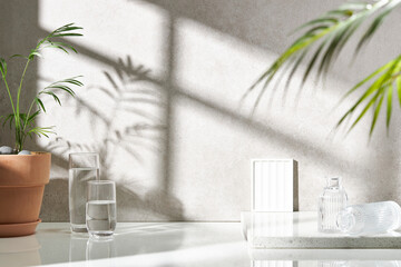 Various objects on a white tile background with warm sunlight shining through
