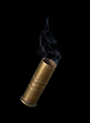 Casing fired with with smoke out of a handgun falling on black background