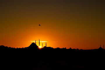 Wall Mural - istanbul silhouette at sunset. clouds over the suleymaniye mosque and sun.