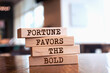 © Uuganbayar - Wooden blocks with words 'Fortune Favors The Bold'.