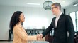 © M Stocker - Businessman caucasian shake hand of African American woman partner client making deal, hiring or thanking for collaboration at diverse business