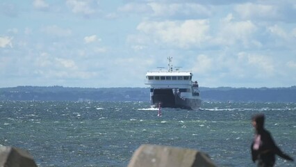 Wall Mural - Car ferry arriving port on a windy day