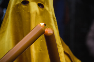 nazareno with candle illuminating the procession on the night of holy friday