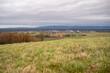 Cityscape of Schaafheim, with agricultural fields in the front and Mountain range in the background during cloudy day, Germany