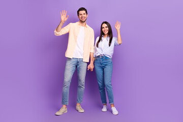 Aufkleber - Full length photo of two positive idyllic people hold arms palms waving hi isolated on violet color background