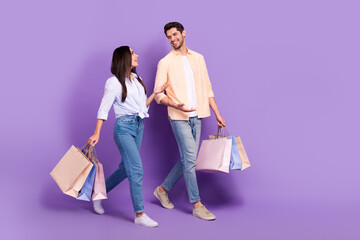 Aufkleber - Full body profile photo of two cheerful friendly partners walk hold bags speak chatting empty space isolated on violet color background